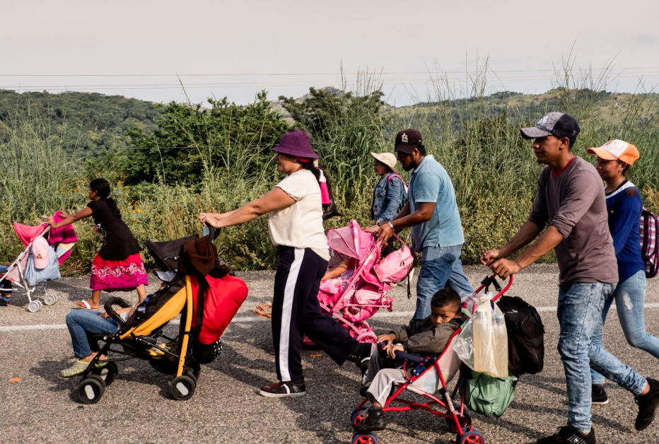 Migrantes centroamericanos caminan con sus hijos en la carretera 190, rumbo al municipio de San Pedro Tapanatepec, Oaxaca, el 27 de octubre. Los cochecitos de bebés se han convertido en un símbolo de este éxodo.